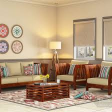 Sofa furniture is that piece of furniture, which gives a conveyable design to any living room. Buy Raiden Wooden Sofa Set Honey Finish Online In India Wooden Street In 2020 Wooden Sofa Set Living Room Sofa Design Wooden Sofa Designs