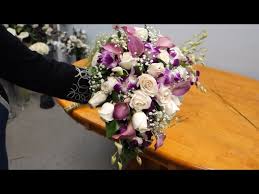 Ivory bouquet of roses, lilies. How To Make A Cascading Bridal Bouquet With Roses Orchids And Calla Lilies Youtube