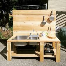 a diy mud kitchen with reclaimed sink