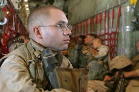 US Marine Corps (USMC) Lance Corporal (LCPL) Ruben Muniz Jr., a fire team  leader with Weapons/Platoon, India Company, 3rd Battalion, 7th Marine  Regiment (India 3/7), sits aboard a KC-130 Hercules aircraft assigned