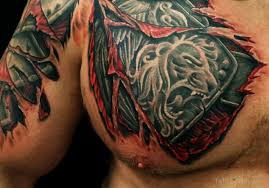 These armor tattoo designs can be done as a plate tattoo, as well as a gauntlet tattoo. Ripped Skin Lion Armor Tattoo On Chest And Shoulder