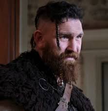 Why does Thorfin from Ghosts wear a twisted wire snaffle as a shawl clasp?