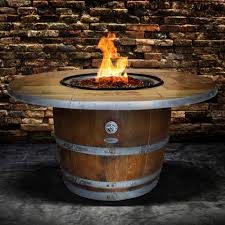 Create a box frame from the wood pieces then place bricks on it to serve as the fire pit table. Vin De Flame Enthusiast Wine Barrel Gas Fire Pit Table