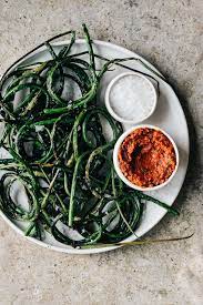 Garlic has documented health benefits. Grilled Garlic Scapes With Sun Dried Tomato Pesto And Sea Salt Dishing Up The Dirt
