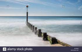 Download This Stock Image A Long Exposure Image Of The Sea Washing Over The Groynes Near Boscombe Pier In Bournemouth Uk Tak Photo Stock Photos Bournemouth