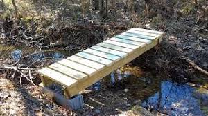 The bridge would be supporting the weight of the boat and the water, but it would be spread out over a greater area. Building A Footbridge Over A Small Creek Youtube