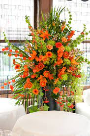 This decorative plant blooms from spring to fall, producing beautiful lime green flowers for the perfect contrasting touch to your garden. Orange And Lime Green Flower Pedestal Arrangement Suitable To Decorate The Reception Church Orange Wedding Flowers Church Flower Arrangements Church Flowers
