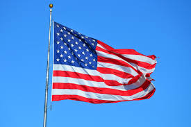 American flag draped over cross. Flag Etiquette For Memorial Day Weekend Emily Post