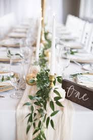 Table Centrepiece Greenery Garland With Gold Candle Holders Tapered Candles Cheeseclot Table Runners Wedding Wedding Table Centerpieces Wedding Candles Table