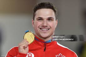 Canada's gymnast Jeremy Chartier displays his gold medal