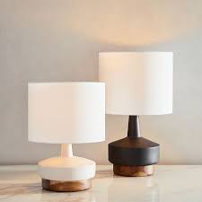 An intricate, raised lattice motif encircles a spherical form. Wood Ceramic Table Lamp Small