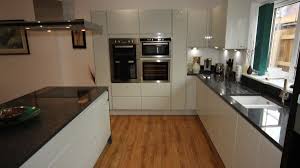 white gloss kitchen with black granite