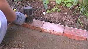 This guide will help you learn how to install brick edging in your yard or garden, along with a decorative garden bed as an option. Laying A Block Edge Course Youtube