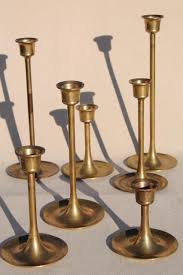 Antique brass arms each hold a single taper candle at dramatic angles and varying heights. Vintage Brass Candlesticks Set In Graduated Heights Minimalist Mod Candle Holders