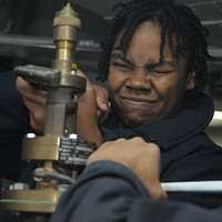 Machinist's Mate Fireman Allyson Jones rebuilds a temperature-regulating  valve aboard aircraft carrier USS George Washington (CVN 73).