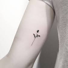 This black and white tattoo that has vines as well as smaller roses. Blackwork Rose Tattoo On The Inner Arm