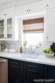 Navy Blue Kitchen Cabinets Are Finished With Long Brass Pulls And White Quartz Countertops Holding A Kitchen Design Kitchen Inspirations Blue Kitchen Cabinets