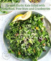 Lemon Garlic Kale Salad With Pistachios Pine Nuts And Cranberries Happily Unprocessed Recipe Garlic Kale Kale Salad Kale
