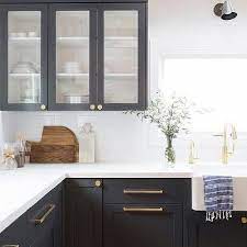 Natural wood open shelves and bright gold hardware enhance the modern vibe. Modern Black Kitchen Cabinets With Gold Hardware Novocom Top