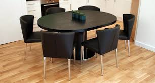 The Curva Black Ash Extending Dining Set Has A Contemporary Black Ash Table Top And Matching Pedestal Black Dining Chairs Ash Dining Tables Oval Table Dining