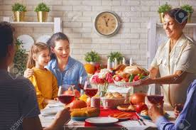 The main table is set with various candles and glasses and. Happy Thanksgiving Day Autumn Feast Family Sitting At The Table And Celebrating Holiday Grandparents Mother Father And Child Traditional Dinner Stock Photo Picture And Royalty Free Image Image 88370646