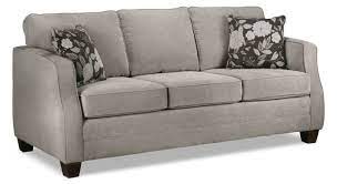 The taupe color on the walls preferred to white paint for the decoration of a contemporary living room to create a subdued atmosphere around a brightly colored sofa. Agnes Sofa Taupe Leon S