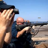 Retired Master Sgt. Richard Thomas fires his pistol