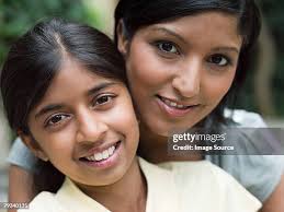 Mother And Daughter Smiling Closeup Portrait High-Res Stock Photo