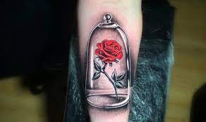 A large tattoo has been drawn on a guys back, with massive petals. Top 71 Beauty And The Beast Rose Tattoo Ideas 2021 Inspiration Guide