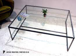 When you think of a glass coffee table you may think of how easily fingerprints can get all over it. Vintage Industrial Glass Top Coffee Table