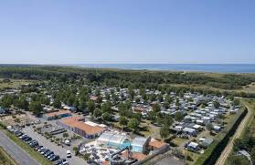 1 back of female trying on bahama hats,background blurred sea and beach,blurred mirror,colorful assortment of hats, copy space. Campingplatz Bahamas Beach In Saint Gilles Croix De Vie Vendee Campingfrance Com