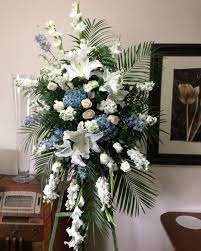 Blue iris with white roses and lilies make for simple and elegant blue and. Funeral Spray Blue And White Funeral Flower Arrangements White Flower Arrangements Diy Flower Arrangements For Funeral