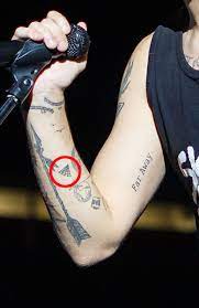 Smiley face with x's for eyes on his arm. Louis Tomlinson 30 Tattoos Guide To His Ink And Their Meanings