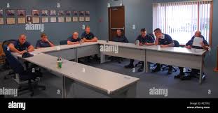 Members of Coast Guard Station Harbor Beach, Mich., stand ready for the  station's morning meeting, Sept. 28, 2015. Pictured in the photo are Petty  Officers 3rd Class Dustin Pitman, Jeffery Neal, Brandon