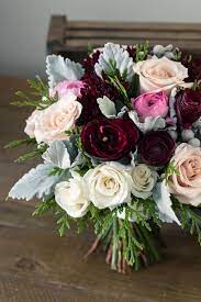 Winter Bridal Bouquet With Dusty Miller Foliage Cedar Deep Burgundy Ranunculus And Quicksand Roses Bou Winter Bridal Bouquets Wedding Flowers Bridal Bouquet