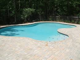 Stone pavers of different sizes and shapes were puzzled for this pool deck. White Based Cement Cobblestone Concrete Paver Pool Deck Pool Pavers Custom Pools Pool Decks