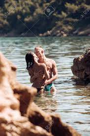 Summer Holidays And Travel On Vacation. Love Relations Of Naked Couple In  Sea Water. Family And Valentines Day Concept. Sexy Woman And Man Have Sex  Games. Couple In Love With Sexy Body