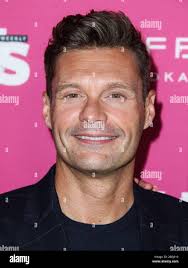 Ryan seacrest black suit hi-res stock photography and images