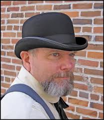A felt hat that is round and hard with a narrow brim. Low Derby Or Bowler Hat