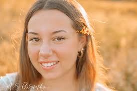 Shes as pretty as a flower so its only suiting she had her senior session  in a field full of them! She loves playing field hockey and is looking  forward to playing