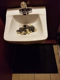 decorative rocks in the sink at the gas