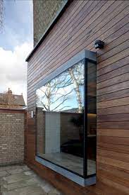 Gray curtains and a gray sofa is a great choice when you don't want to turn a bay window into a focal point. The Slide To Outside 7 Ways To Use Sliding Glass Doors In Your Home Decor Bay Window Exterior House Exterior Windows Exterior
