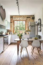 Modern Rustic Kitchen With Wood Floors Brick Wall White Chairs And Brass Lamp Home House Interior Home Decor