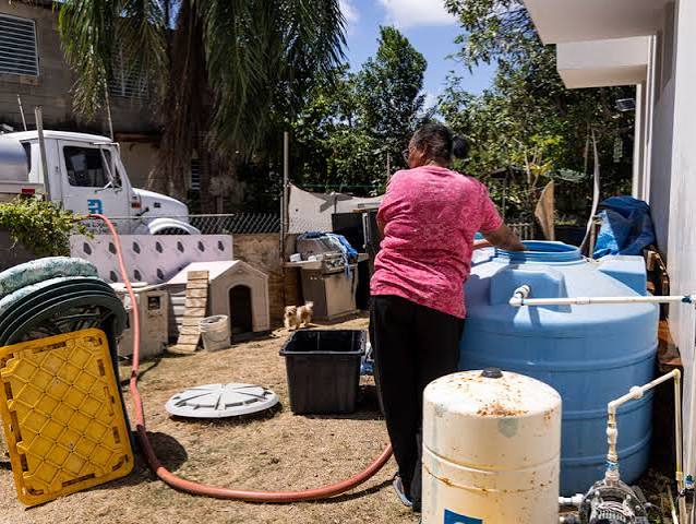 A residential street in Puerto Rico during water rationing measures, highlighting the impact on local communities.