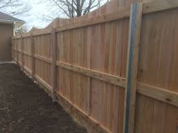 Postmaster steel fence post vs traditional wood post. Roy Son Fencing Kansas City Fence Contractor