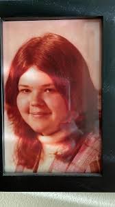 person shows off shag haircut and homemade plaid jacket