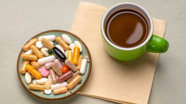 Pharmacist holding two identical tablets showing manufacturing differences and absorption factors
