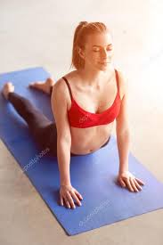 Front View Of Young Woman Doing Upward Facing Dog Yoga Stock Photo C Kegfire 127545304