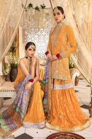 This is a relaxed babydoll dress with lace detailing, flutter sleeves and a crew neckline. Anaya By Kiran Chaudhry Mehendi Collection Nauratan Amber Akm 01