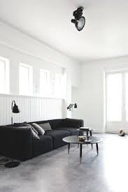 23 Pictures That Show How Concrete Floors Have Been Used Throughout Homes Black And White Living Room Home Living Room Designs
